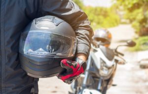 Man In A Motorcycle With Helmet And Gloves Is An Important Prote